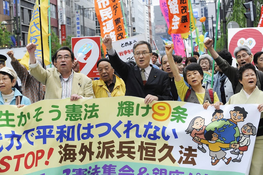 Protesters shout slogans during their demonstration march to support the war-renouncing Japanese constitution