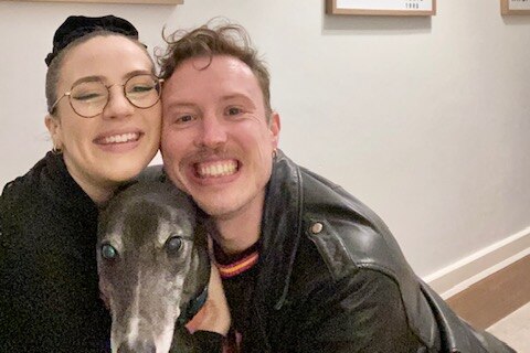 Patrick and his partner Eilish pose for a selife with their greyhound, Basil.