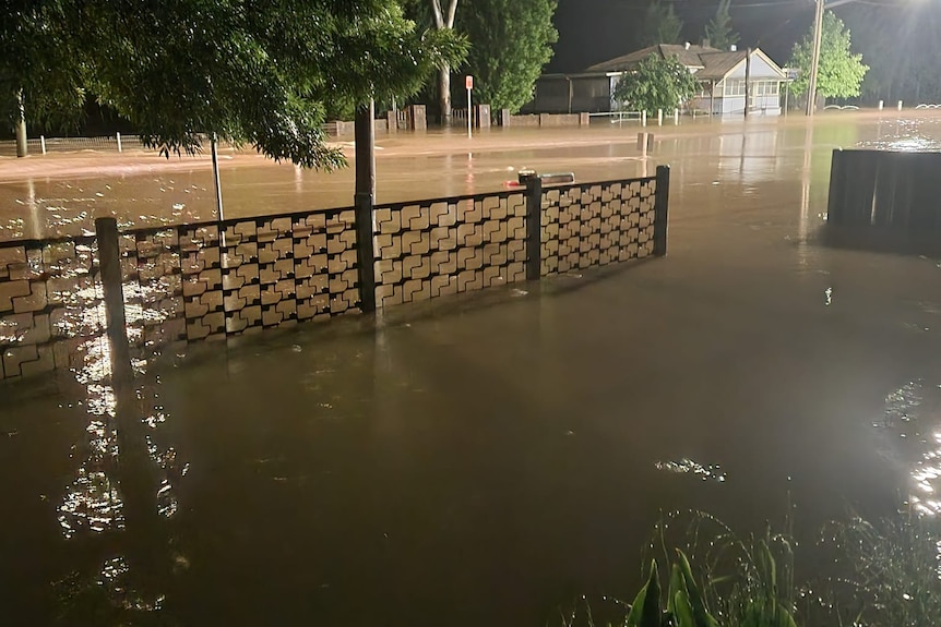 A suburban street filled with brown water