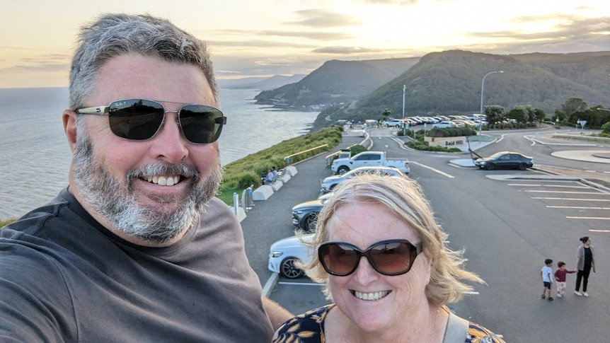 Michael takes a selfie standing next to his wife