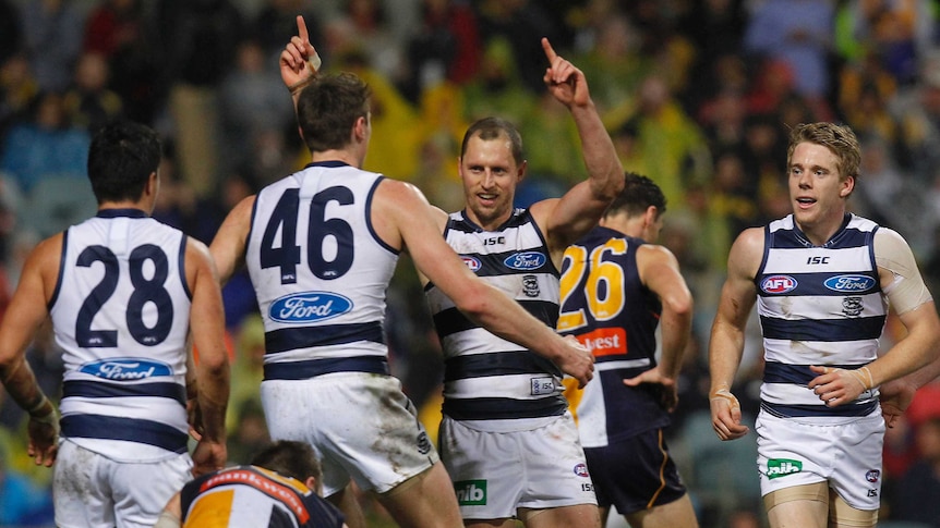 Geelong's James Kelly (C) celebrates after kicking a goal against West Coast at Subiaco.