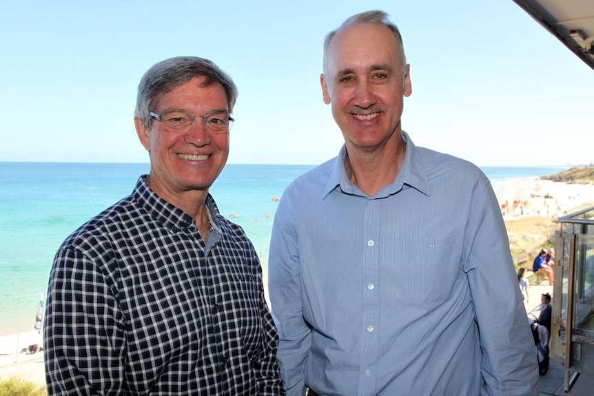 Liberal leader Mike Nahan stands on a balcony with the beach in the background with just-elected Cottesloe MP David Honey.