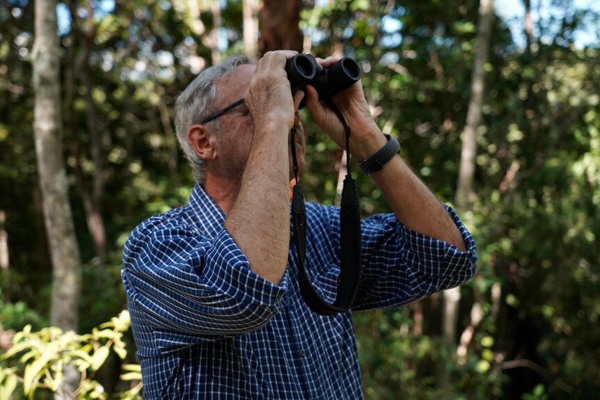 Man standing with binoculars