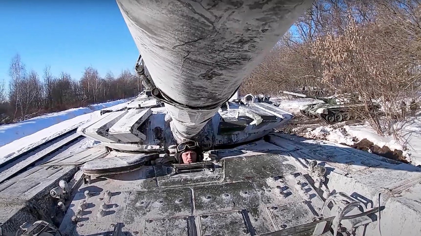 Russian army tanks are loaded onto railway platforms.