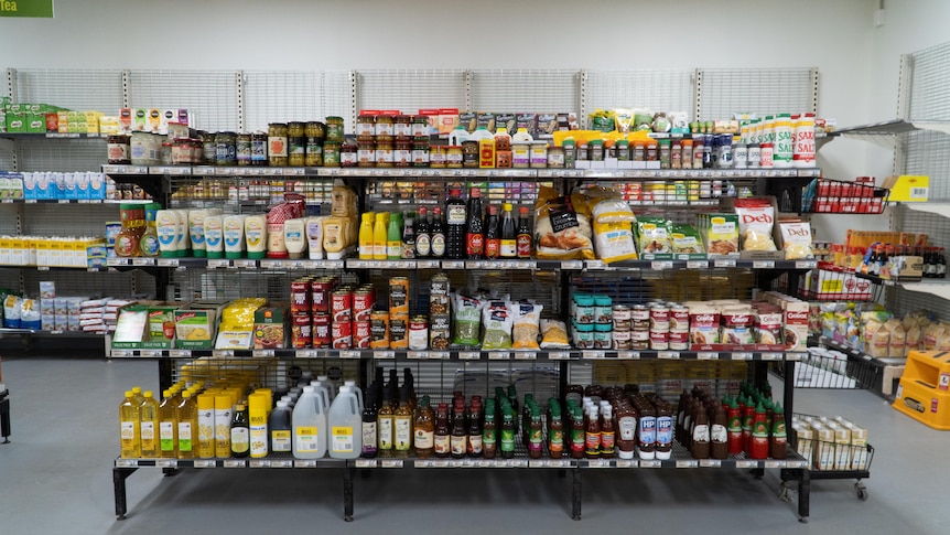 Groceries and other goods on a shelf in a supermarket