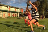 Young footballers in Darebin do leg exercised on a football oval.