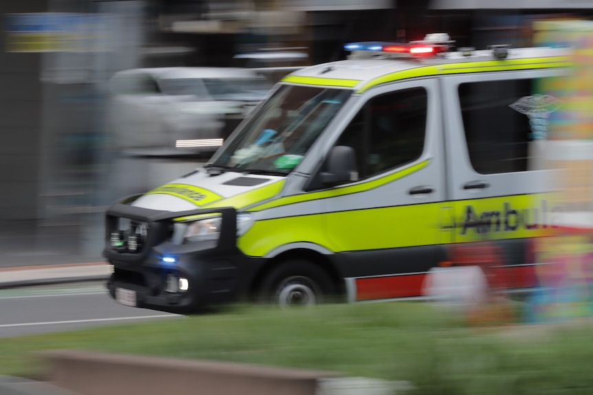 A Queensland Ambulance Vehicle driving fast. GOOD GENERIC.