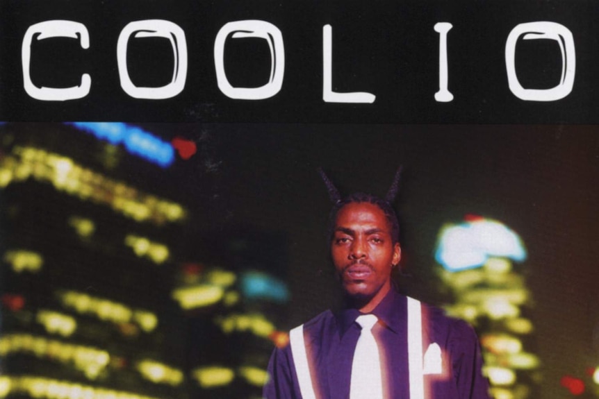 An album cover featuring a nicely dressed rapper wearing a tie and suspenders.