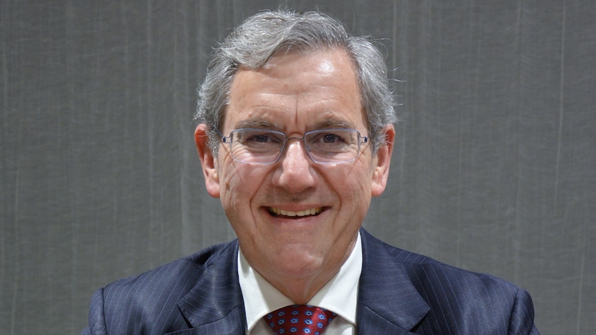 Picture of ASIC chair Joseph Longo in suit and tie smiling.