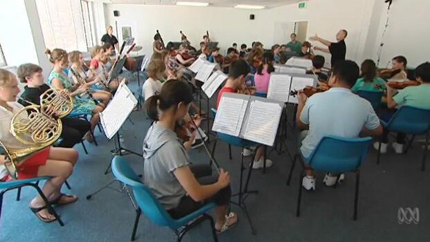 Children play instruments in an orchestra
