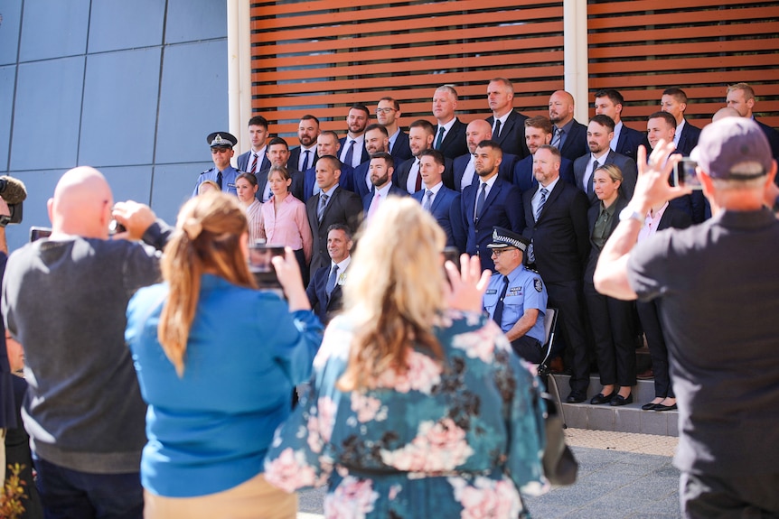 Police recruits pose for an official photo