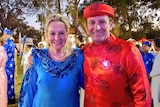 Alannah McTiernan and Mark McGowan pose for the camera wearing traditional blue and red Vietnamese outfits.