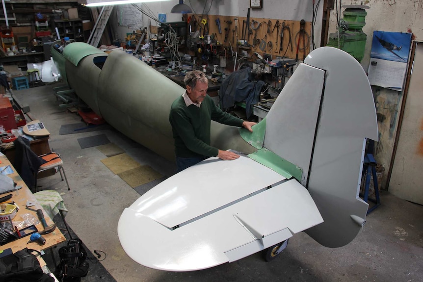 Rod McNeill putting together his spitfire in his shed.