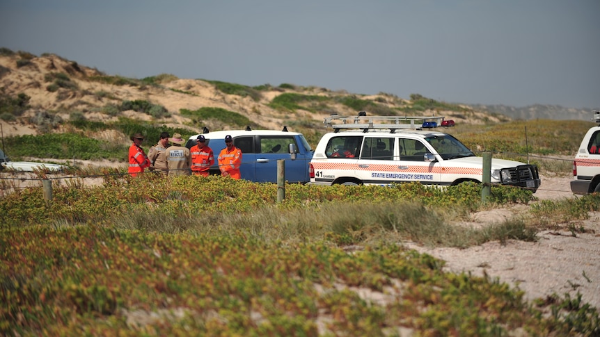 SES officials near cars during jury visit to Salt Creek.