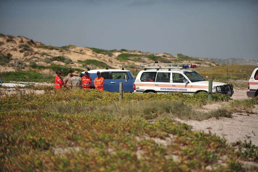 SES officials near cars during jury visit to Salt Creek.