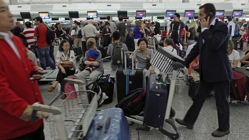 Stranded travellers gather at the Qantas check-in area at Hong Kong's international airport on October 29, 2011.
