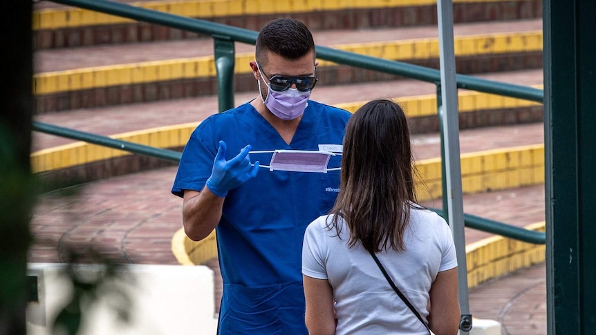 A man at a Bondi clinic preparing a mask for a patient