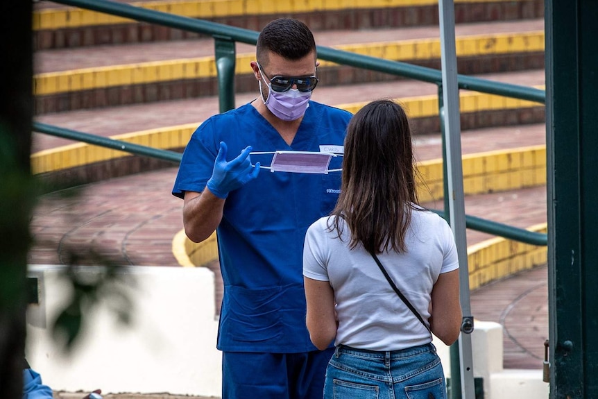 A man at a Bondi clinic preparing a mask for a patient