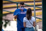 A man at a Bondi clinic preparing a mask for a patient
