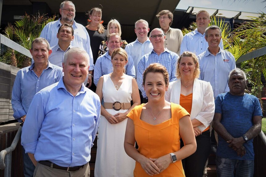 16 CLP candidates stand together at the Darwin Waterfront for a group photo.