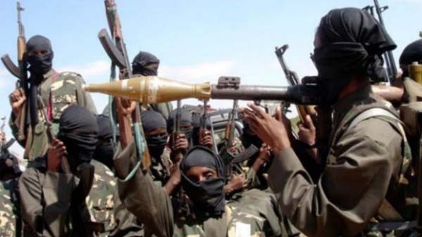 On a raid in Nigeria, members of Boko Haram hold guns and missile launcher