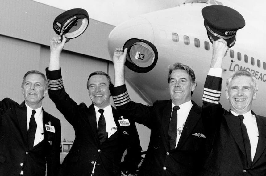 Qantas pilots Rob Greenop, David Massy-Greene, Ray Heiniger and George Lindeman hold their hats up in front of the 747.