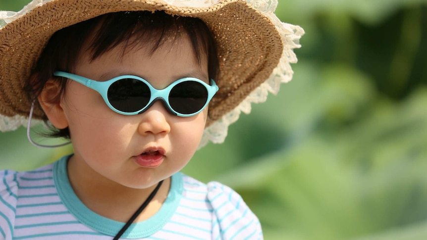 Child wearing sunglasses and a hat