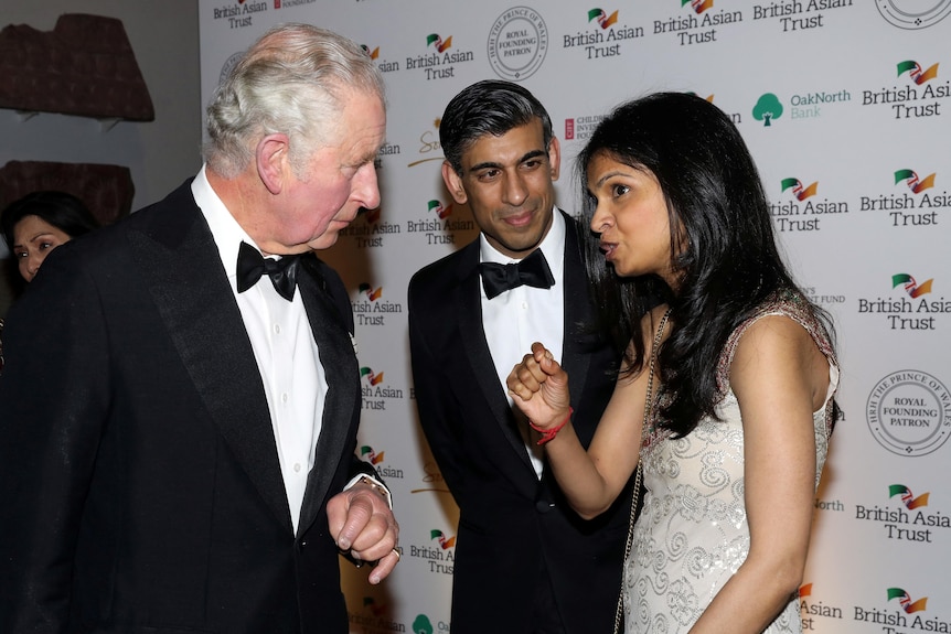 Prince Charles speaks to British Chancellor of the Exchequer Rishi Sunak and Akshata Murthy at a black tie event.
