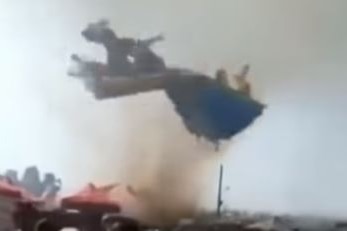 A video still shows a jumping castle upside down in the air.