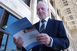 Auditor-general Colin Murphy holds the real estate report