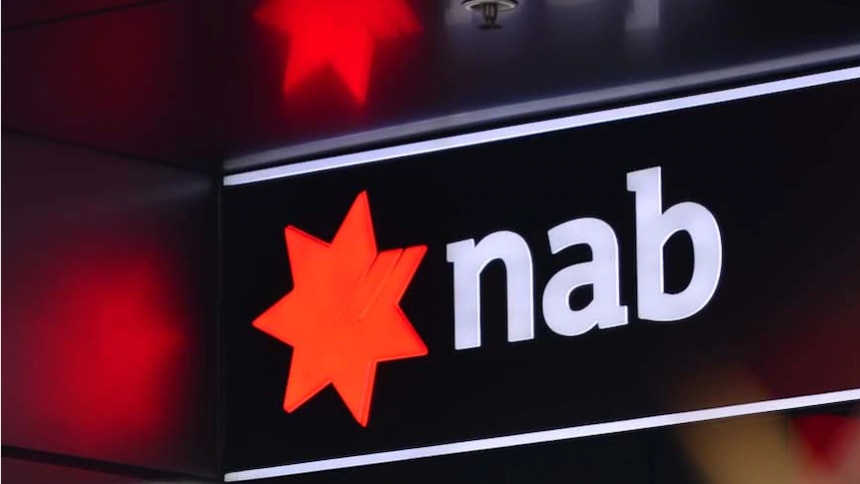NAB sign with red star logo and 'nab' in white lettering. Red star reflects off corresponding roof and walls.
