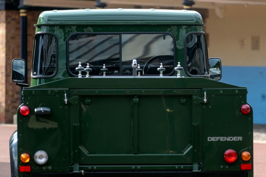 the back of a  green land rover which has been modified