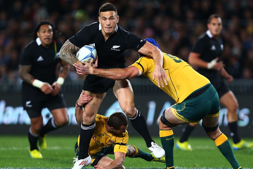 On the burst ... Sonny Bill Willams looks to beat the tackle of Quade Cooper and Nathan Sharpe