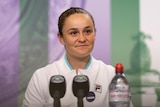 Ash Barty smiles during a press conference after winning Wimbledon