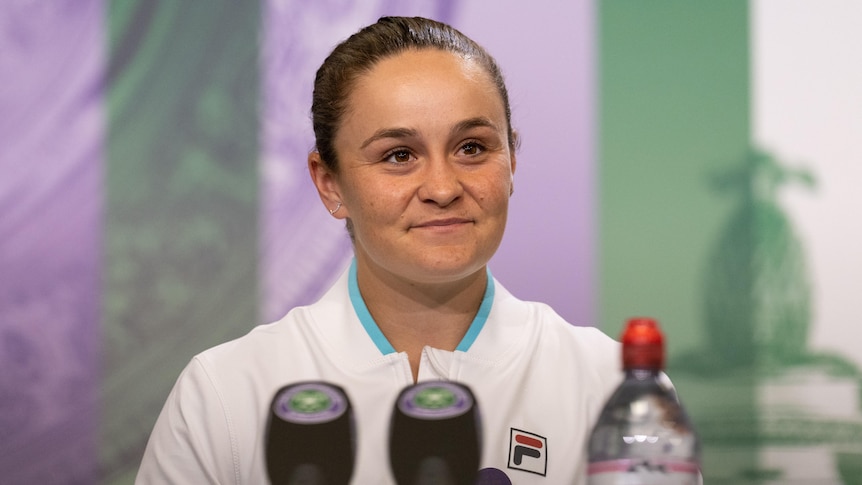 Ash Barty smiles during a press conference after winning Wimbledon