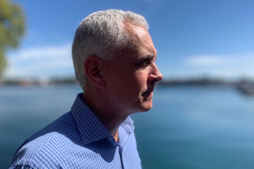 Side-on profile shot of TWU national secretary Michael Kaine in front of the water.