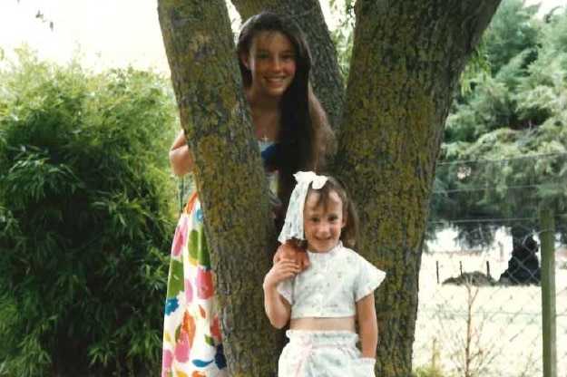 Eve van Grafhorst stands in front of her sister Dana.