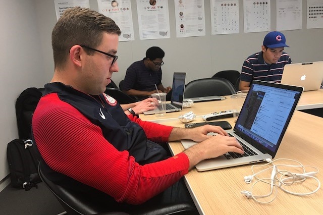 SI.com's NBA editor Matt Dollinger looks intently at his laptop while covering the drafts.