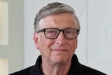 Bill Gates wears a black tip and glasses.