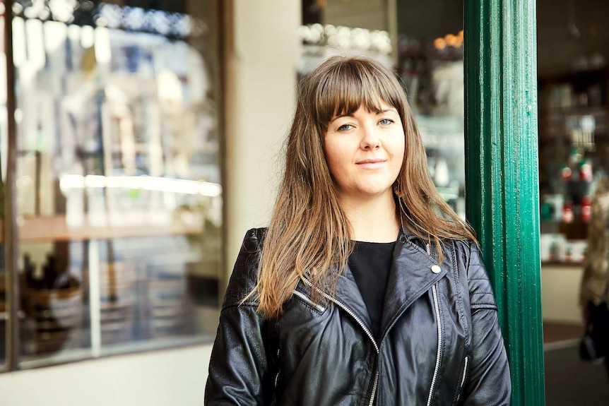 Elly Danks, a young woman with light brown hair, looks calmly at the camera.