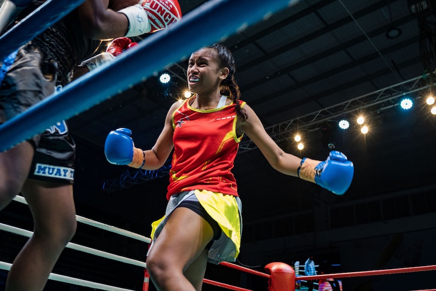 Jasmine Daunakamakama throws a punch in a boxing ring.