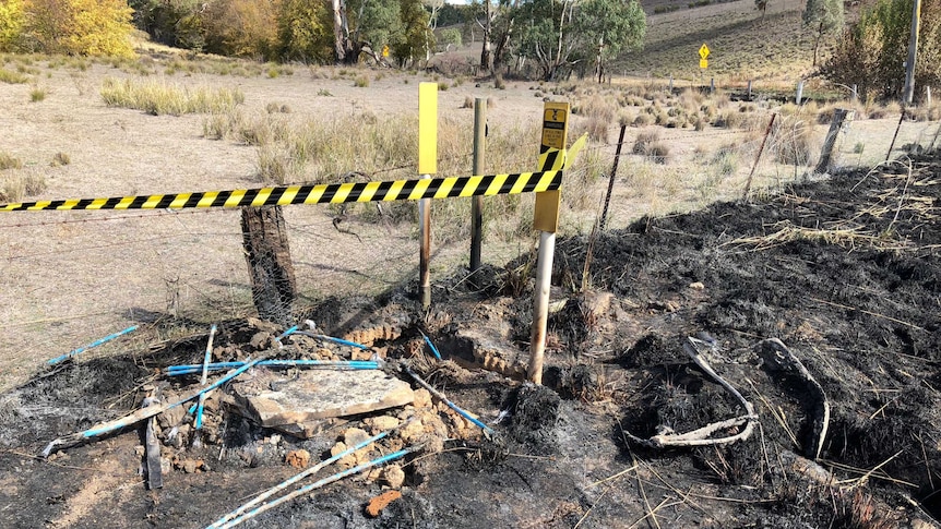 A Telstra telecommunications pit which is burnt out by fire