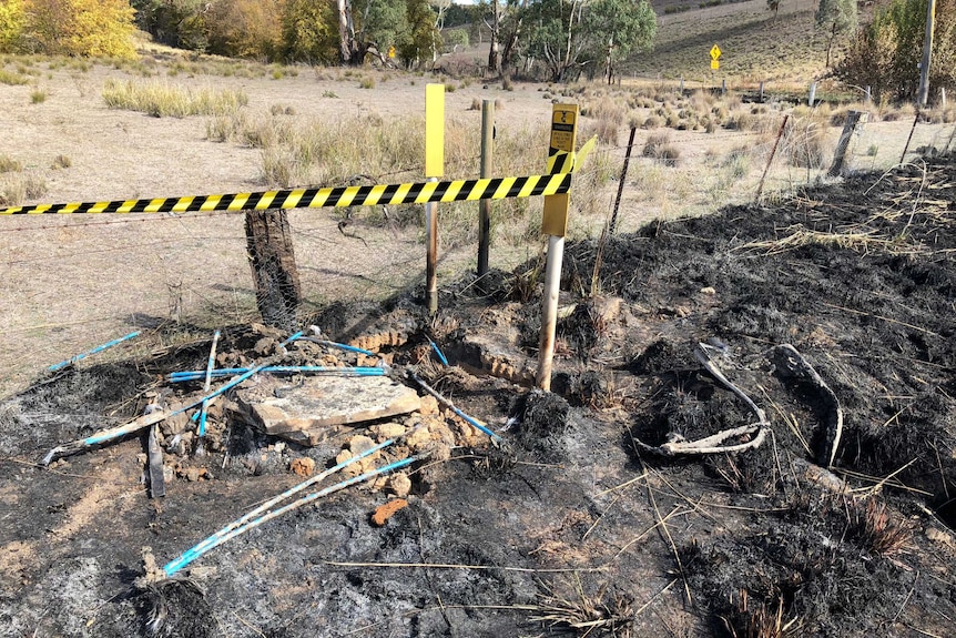 A Telstra telecommunications pit which is burnt out by fire