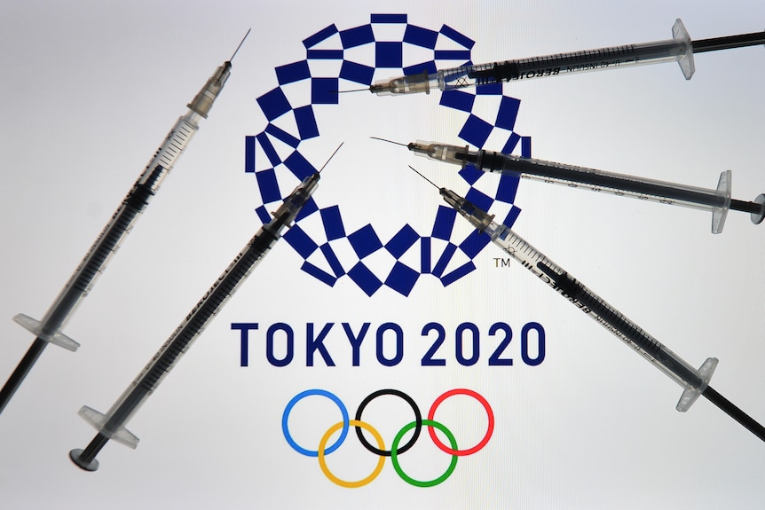 Medical syringes are shown on top of the Tokyo 2020 logo and Olympic rings
