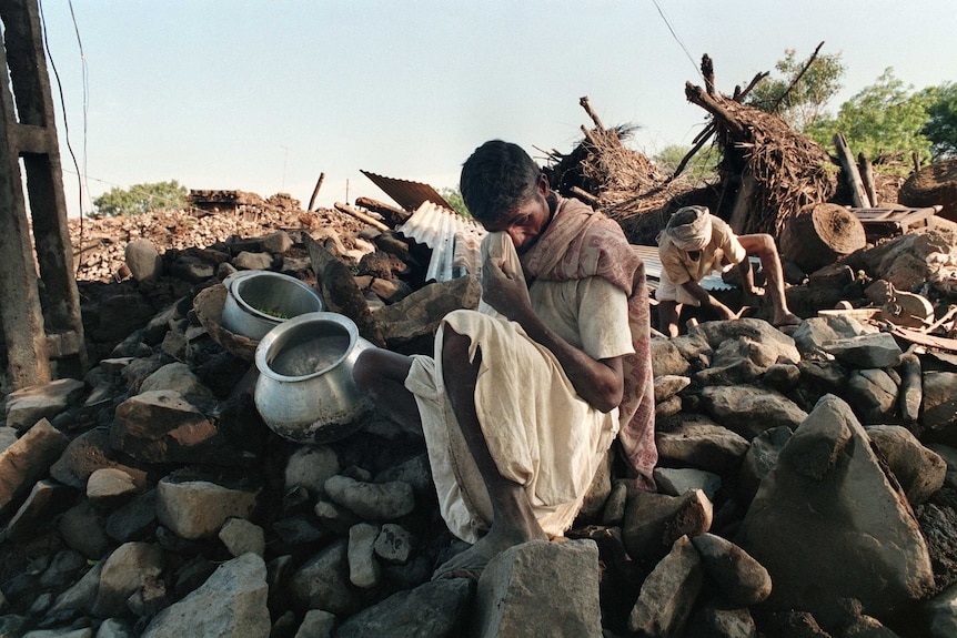 A man grieves in Talani village for his son killed by an earthquake in India