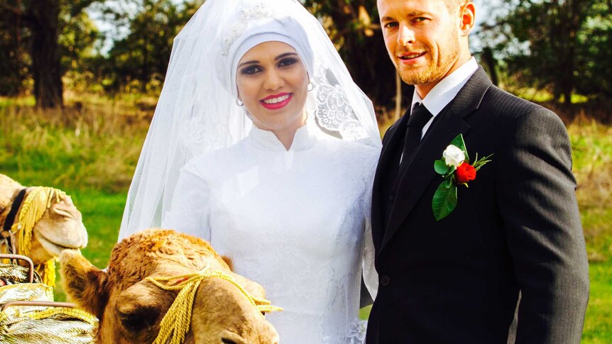 Noora Al Matori and Bogart Lamprey with a camel on their wedding day.