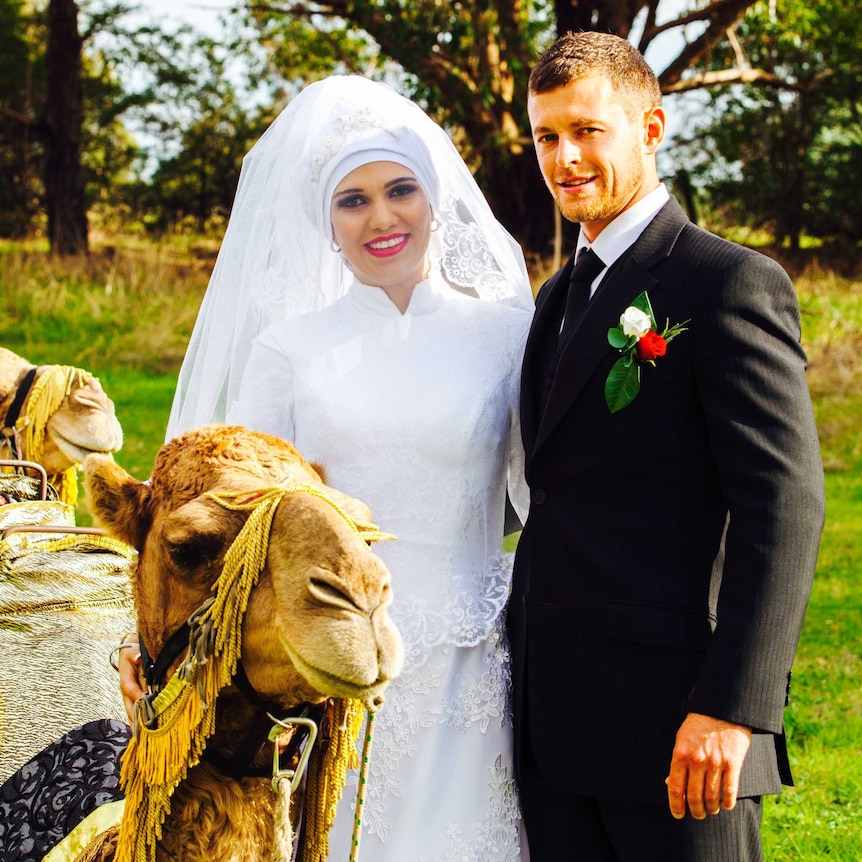Noora Al Matori and Bogart Lamprey with a camel on their wedding day.