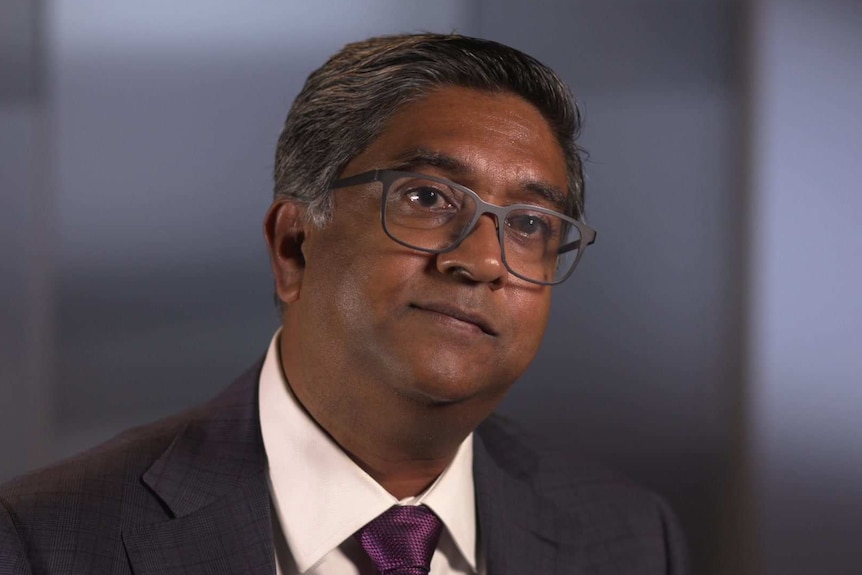 Pradeep Philip wears a suit and tie