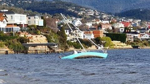 A yacht lists to the side in the River Derwent.