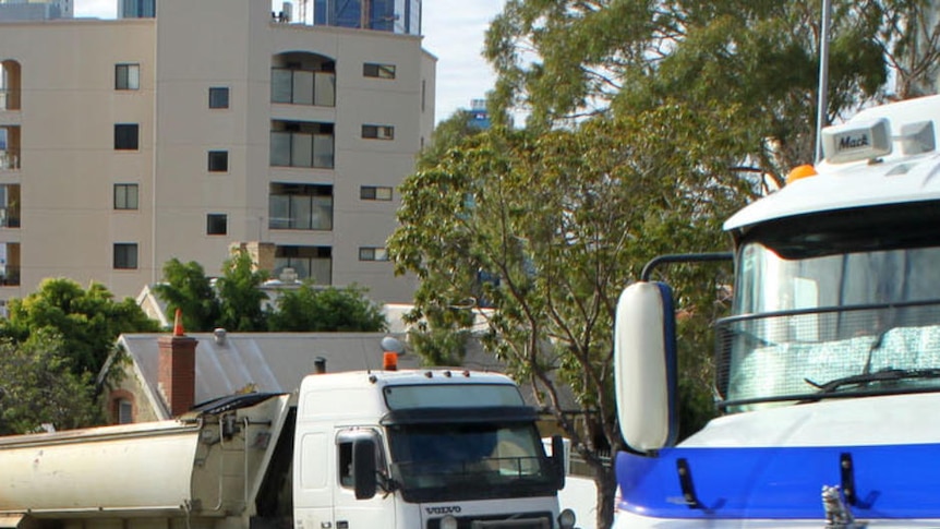 Truck convoy driving to Parliament house in Perth to protest rising costs